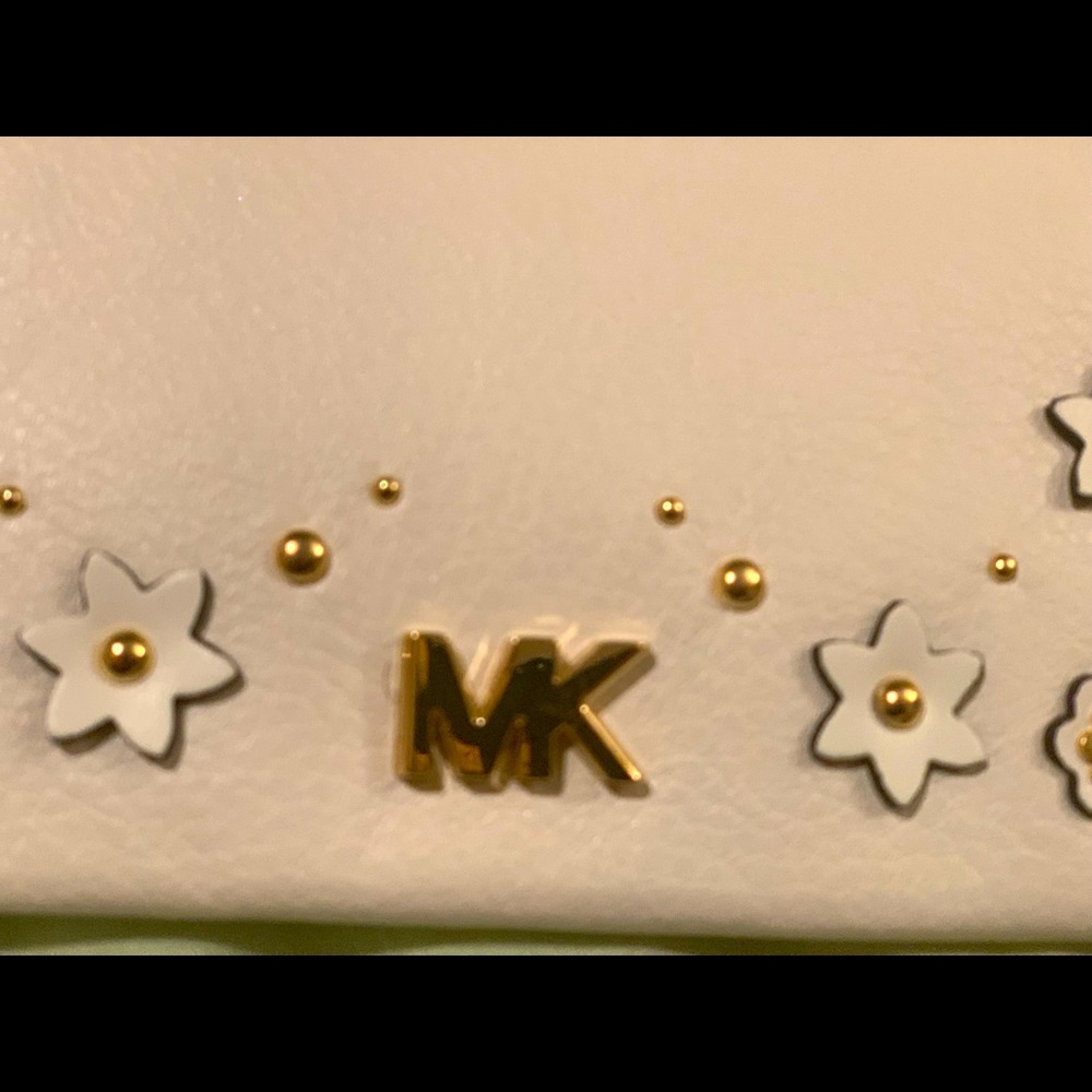 New gorgeous Michael Kors leather clutch with handle and ornaments . .Must have